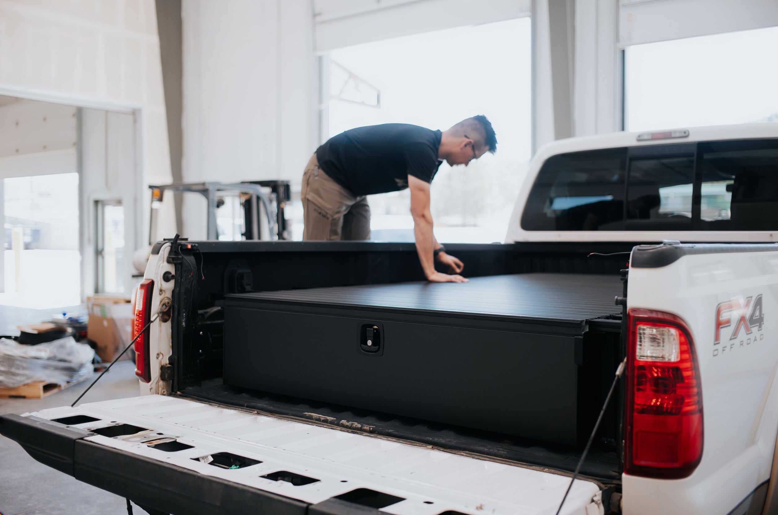 Silver Bullet founder installing and checking a truck-bed drawer system in Palmer Lake, Colorado