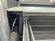Load image into Gallery viewer, Close detail of the Silver Bullet platform edge and slide rails installed in a 2021 Chevrolet Silverado 1500 bed

