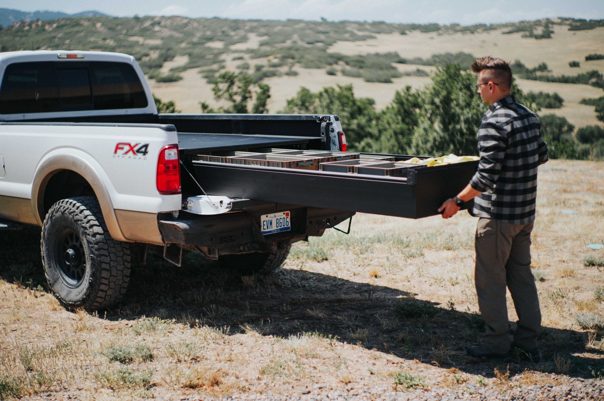 Silver Bullet founder Isaac Tussey pulling the ultra-wide drawer to full extension beside the truck